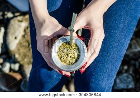 Young Woman Drinking Traditional Argentinian Yerba Mate Tea From Calabash Gourd