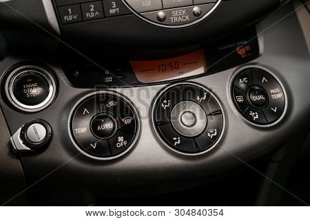 Сlose-up Of The Car  Black Interior: Dasboard With Clock, Start Engine Buttons, Adjustment Of The Bl