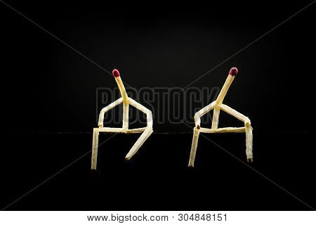 Two Characters Made Of Matchsticks Sad And Sitting In The Dark, One Away From The Other. Concept Of