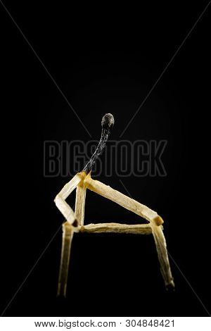 Image Of A Man Made Of Matchstick. Small And Depressive In The Dark, Erased And Losing The Flame. Co
