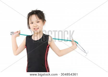 Pretty Asian Girl In Sportswear Wears Green Stechoscope And Posing To Camera, Studio Shot On White B