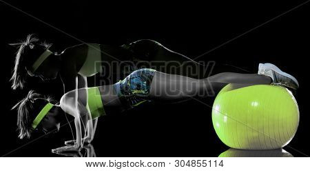 one mixed race woman exercising fitness exercises isolated on black background with lightpainting effect