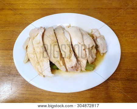 Chinese Food Style, Top View Of Steamed Chicken In White Plate On Wooden Table, Hainanese Chicken Ri
