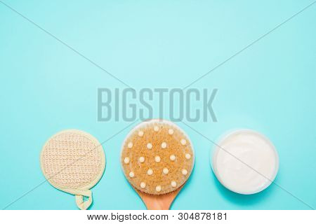 Body Massage Brush With Cream On Blue Background. Massage Brush For The Body. Skin Care Products. Sp
