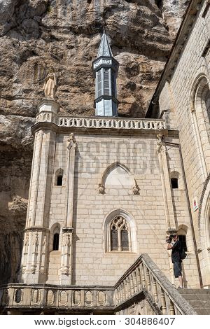 Rocamadour, France - September 3, 2018: Stone Walls Of Historic Basilica Of St-sauveur Blend Into Th