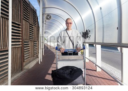Young Woman Transporting Luggage From Arrival Parking To International Airport Departure Termainal B