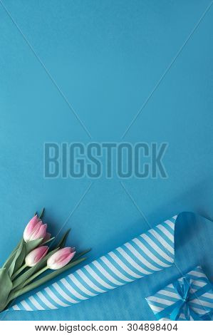 Blue Background With Pink Tulips, Stripy Wrapping Paper And Wrapped Gift Boxes, Copy-space