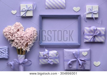Purple Springtime  Background With Pink Hyacinth Flowers, Wrapped Gift Boxes And Decorative Hearts A