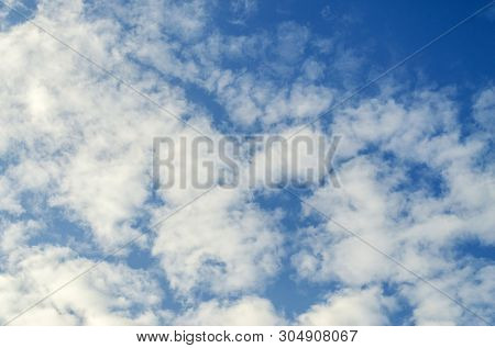 Blue Sky And White Shapeless Clouds On It