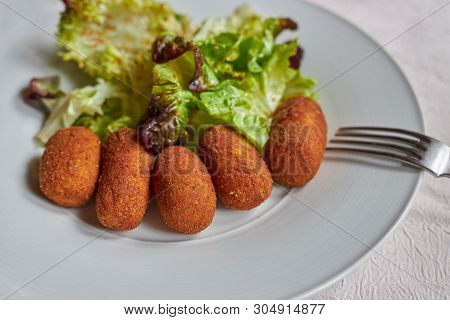 Green Salad And Chicken Croquette In Spanish Restaurant