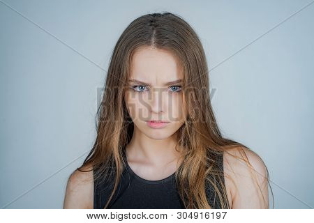 Fashion Portrait Of A Beautiful Young Woman Posing Over White Background. Close Up Portrait Of A Bea