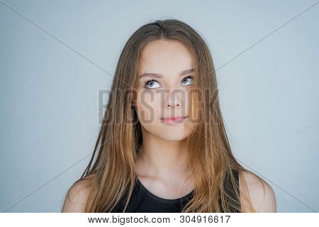 Close Up Portrait Of A Beautiful Young Woman With Blonde Hair. Caucasian Woman Model Posing Indoors