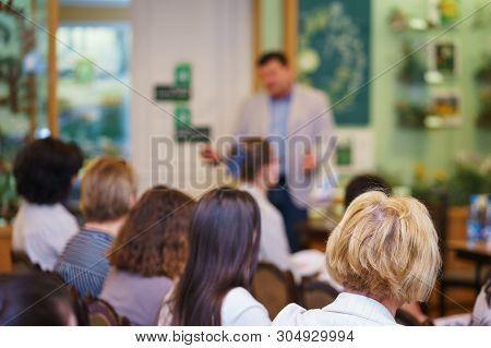 Conference Participants, Events, Presentations, Listen To The Speaker Sitting In Chairs. Rear View O