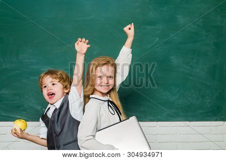 Woohoo. Cheerful Smiling Child At The Blackboard. Schoolchild. Book School And Kids. Classroom. Scho