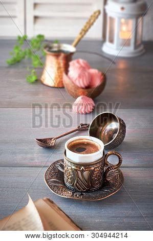 Oriental Coffee Cooked In Traditional Turkish Copper Coffee Pot And  Served In A Matching Cup In Orn