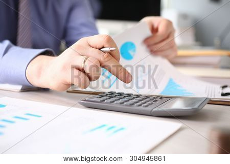 Calculating Finance Budget Tax Report Process. Male Person Working On Financial Document With Calcul