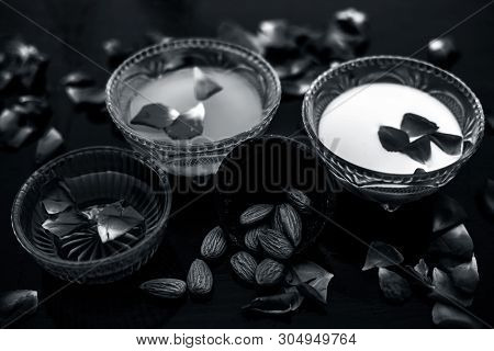 Milk And Almond Face Pack On Black Colored Shiny Surface I.e. Raw Milk,almond,honey Well Mixed In A