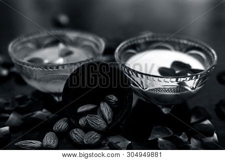 Milk And Almond Face Pack On Black Colored Shiny Surface I.e. Raw Milk,almond,honey Well Mixed In A