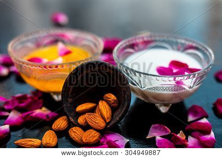 Milk And Almond Face Pack On Black Colored Shiny Surface I.e. Raw Milk,almond,honey Well Mixed In A