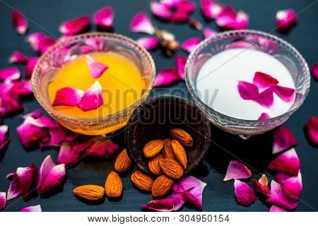 Milk And Almond Face Pack On Black Colored Shiny Surface I.e. Raw Milk,almond,honey Well Mixed In A