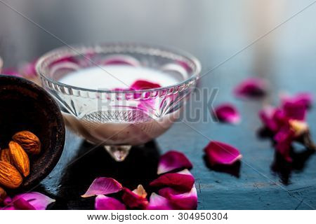 Milk And Almond Face Pack On Black Colored Shiny Surface I.e. Raw Milk,almond,honey Well Mixed In A