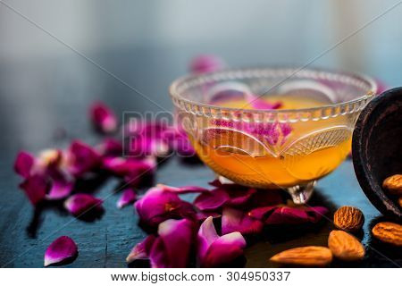 Milk And Almond Face Pack On Black Colored Shiny Surface I.e. Raw Milk,almond,honey Well Mixed In A