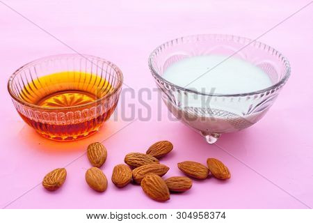 Milk And Almond Face Pack On Isolated On Pink Surface I.e. Raw Milk,almond,honey Well Mixed In A Gla