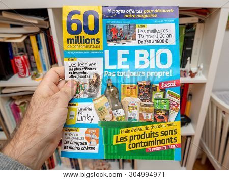 Paris, France - Mar 16, 2019: Man Hand Reading 60 Million De Consommateur Review Magazine Newspaper 