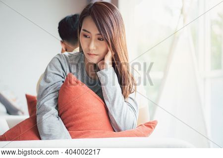Unhappy Couple Sitting Behind Each Other On The Couch And Avoid Talking Or Looking At Each Other, Ca
