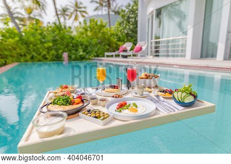 Breakfast In Swimming Pool, Floating Breakfast In Luxurious Tropical Resort. Table Relaxing On Calm 