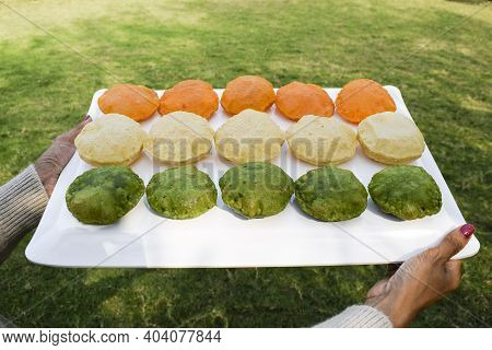 Female Holding Homemade Colourful Puris Made From Spinach, Carrot, On Occasion Of Indian Republic Da
