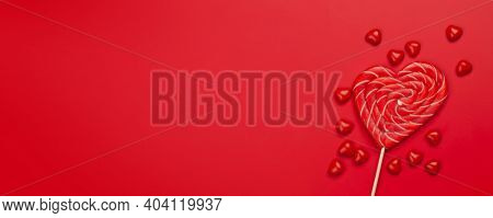 Valentines day greeting card template. Heart candy sweets over red background. Top view flat lay with copy space