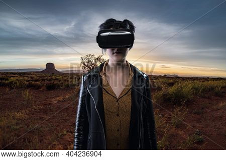 Woman Wearing A Virtual Reality Headset In A Simulated Hiking Experience Through The Desert.  Vr Tou