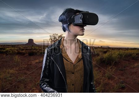 Woman Wearing A Virtual Reality Headset In A Simulated Hiking Experience Through The Desert.  Vr Tou