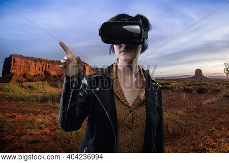 Woman Wearing A Virtual Reality Headset In A Simulated Hiking Experience Through The Desert.  Vr Tou