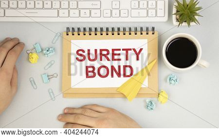 Paper With Surety Bond On Table With Chart . Business Concept