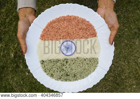 Female Holding Plate Of Tri Color Or Tiranga Indian Flag Food Depicted By Coloured Rice Grains. Natu