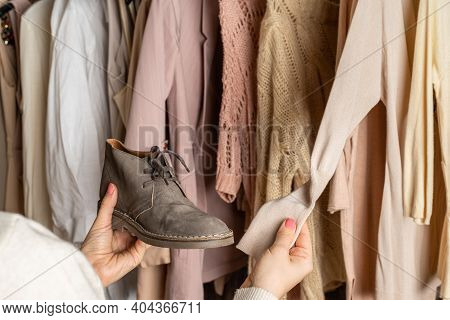Woman Choosing Boots (shoes) And Clothes In Home Cupboard. Season Concept