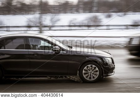 Moscow, Russia - January 15, 2021: Fast Moving Black Car With Motion Blur Effect. Overspeed Concept.