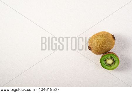 Kiwi Fruits Half Sliced On White Background, Copy Space, Top View