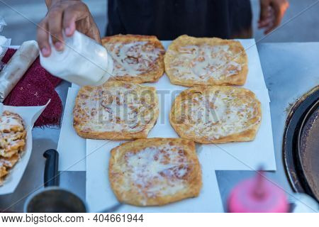 Roti Making, Roti Thresh Flour By Roti Maker With Oil. Indian Traditional Street Food. Thai Pancake 