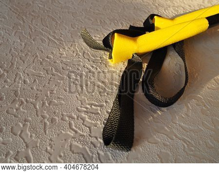 Yellow-black Ski Poles On The Table Close-up. Plastic Holders - Handrails, Synthetic Material Hinges
