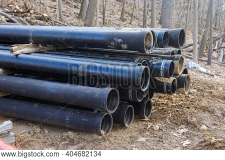 Plastic Main Black Pipes On Heap Of Polyethylene Pipes For A Water Supply System For Laying Urban Co