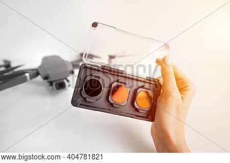 Woman Holding Nd Filters And Polarising Filters Set For Drone. Filters For The Drone Camera.