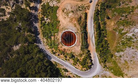 Top View Of Sinkhole. Clip. Incredible Natural Phenomenon In Form Of Sinkhole With Brown Water In Fi