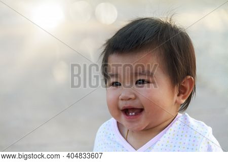 Close Up Portrait Little Girl. Cute Adorable Asian Little Girl Play In Park With Sun Ray Background.