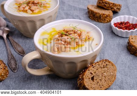 Vegetable Cream Soup With Beans And Spicy Oil In A Bowl On A Textile Background. Selective Focus.