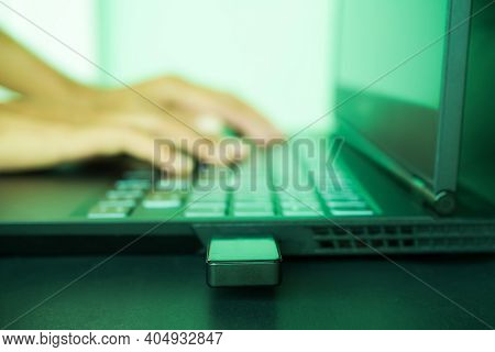 Data Theft Or Identity Theft Concept. Blur Image And Green Light Of Finger Typing Keyboard Laptop Wi
