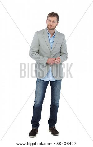 Suave man in a blazer posing on white background