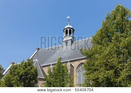 Dutch Church With Slate Roof Against A Blue Sky